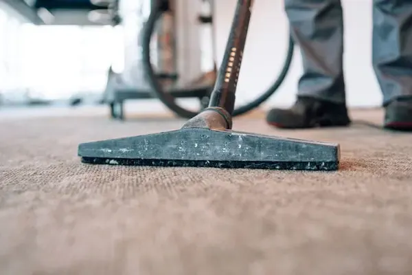 Extraction wand pulling water out of a soaked carpet in an Elmhurst, NY apartment